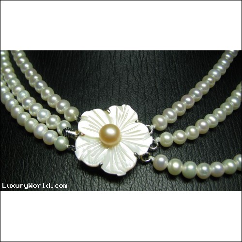 TRIPLE STRAND OF FRESHWATER PEARLS WITH MOP FLOWER CLASP $1NR
